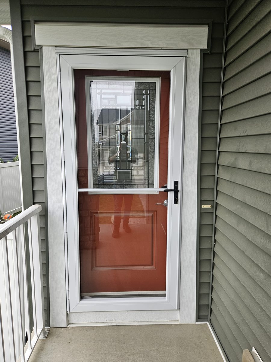 Andersen 3000 full-view storm door over a red entry door in Calgary