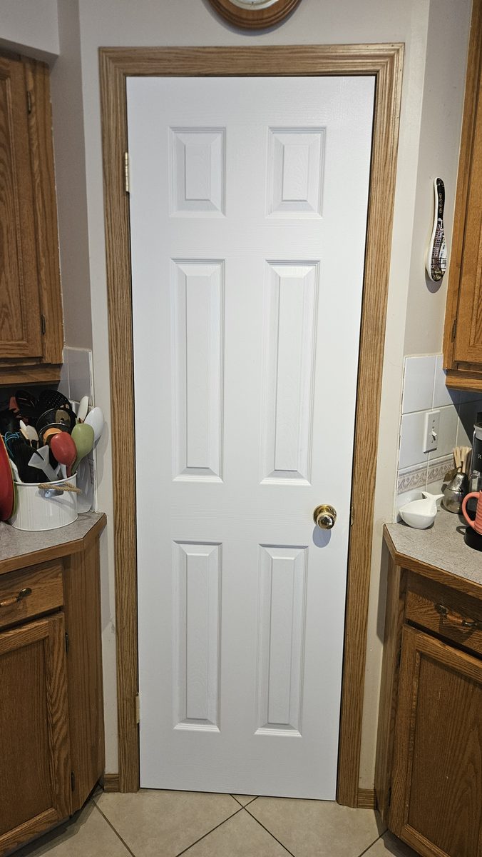 New six-panel pantry door with spice rack in Harvest Glen, Calgary