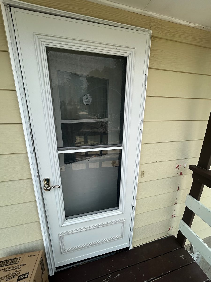 Old storm door before replacement in Pineridge, Calgary